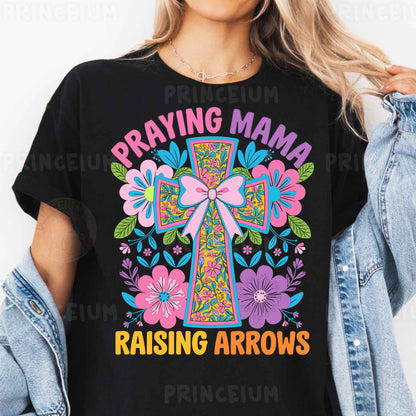 a woman wearing a black t - shirt that says praying mama raising arrows