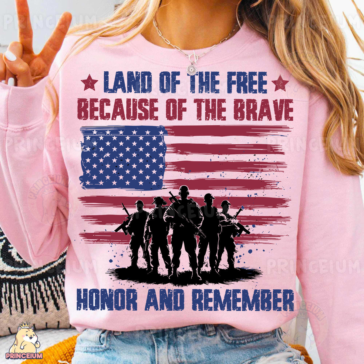 a woman wearing a pink shirt that says land of the free because of the brave