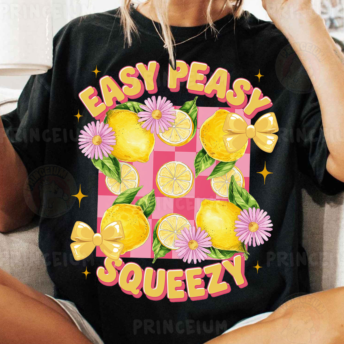 a woman sitting on a couch wearing a t - shirt with lemons and dai
