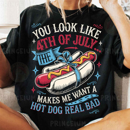 a woman sitting on a couch with a hot dog on her shirt