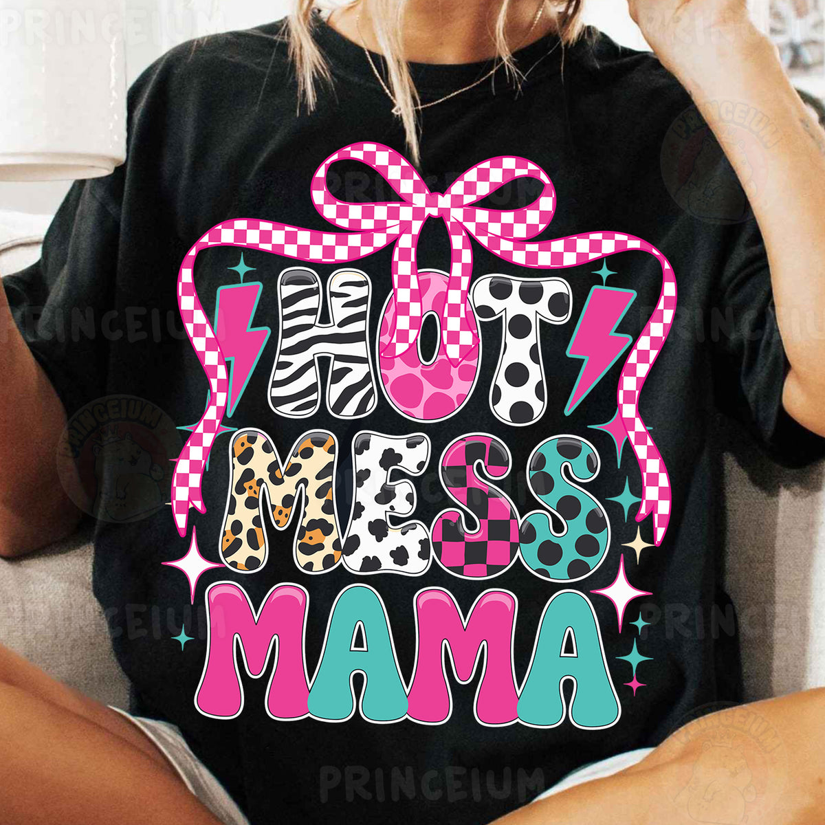 a woman sitting on a couch wearing a black shirt with a pink bow