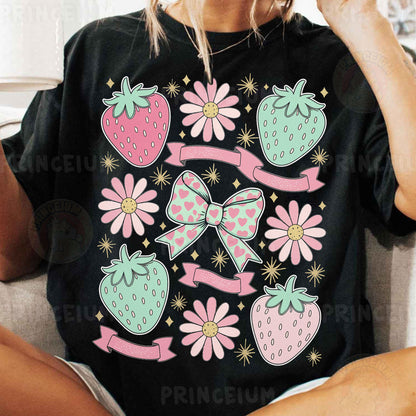a woman sitting on a couch wearing a black shirt with pink flowers and strawberries