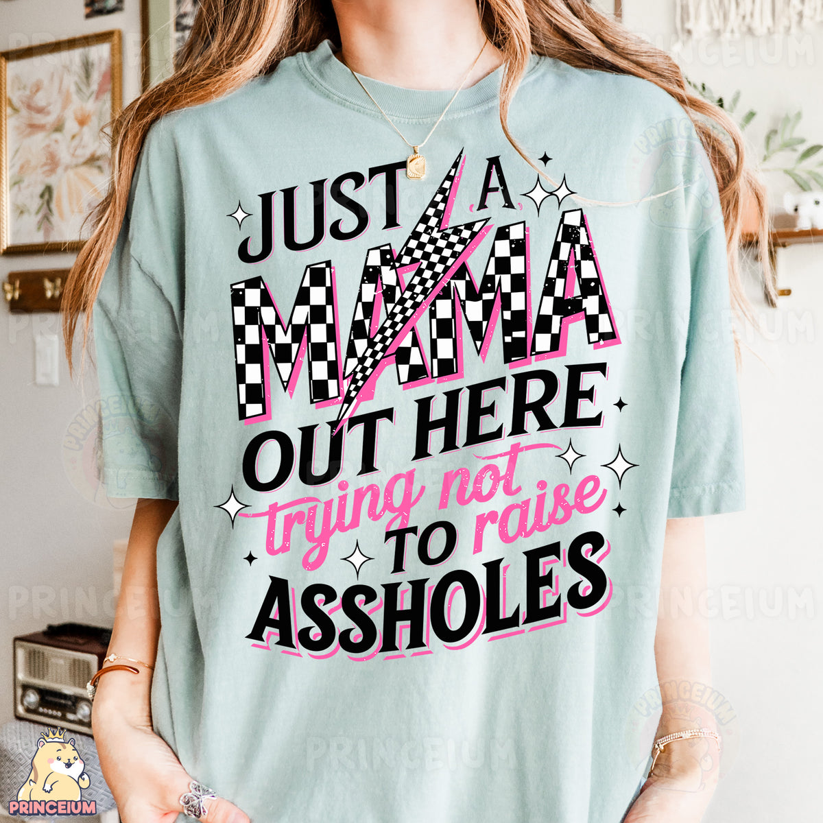 a woman wearing a t - shirt that says just a mama out here trying to