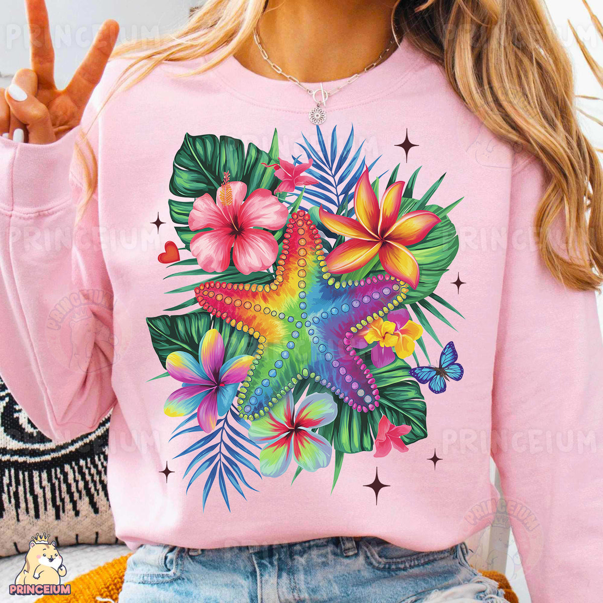 a woman wearing a pink shirt with a starfish and flowers on it