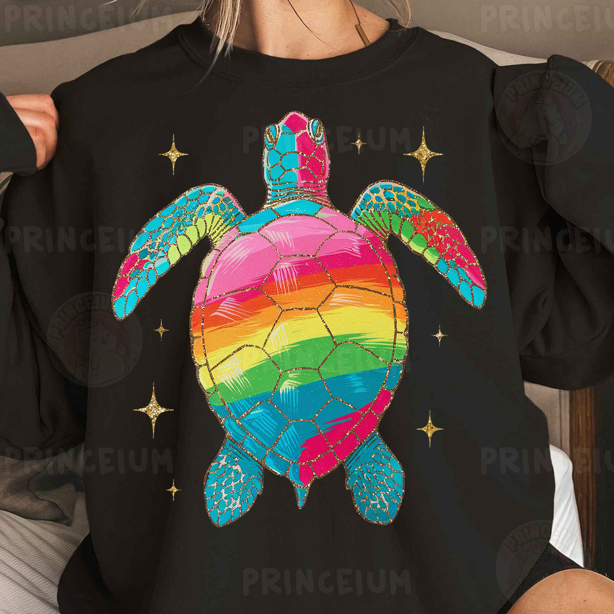 a woman wearing a black shirt with a rainbow turtle on it