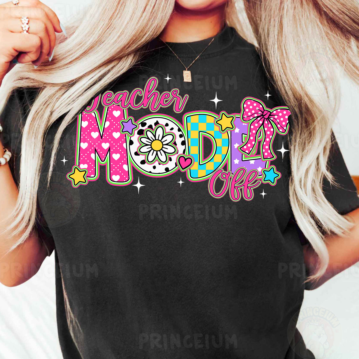 a woman wearing a black teacher mom shirt