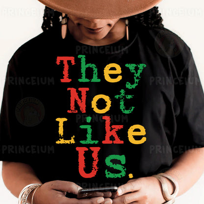 a woman wearing a black shirt with the words they not like us on it