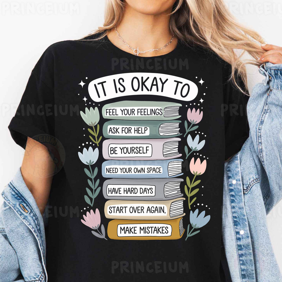 a woman wearing a t - shirt that says it is okay to read books