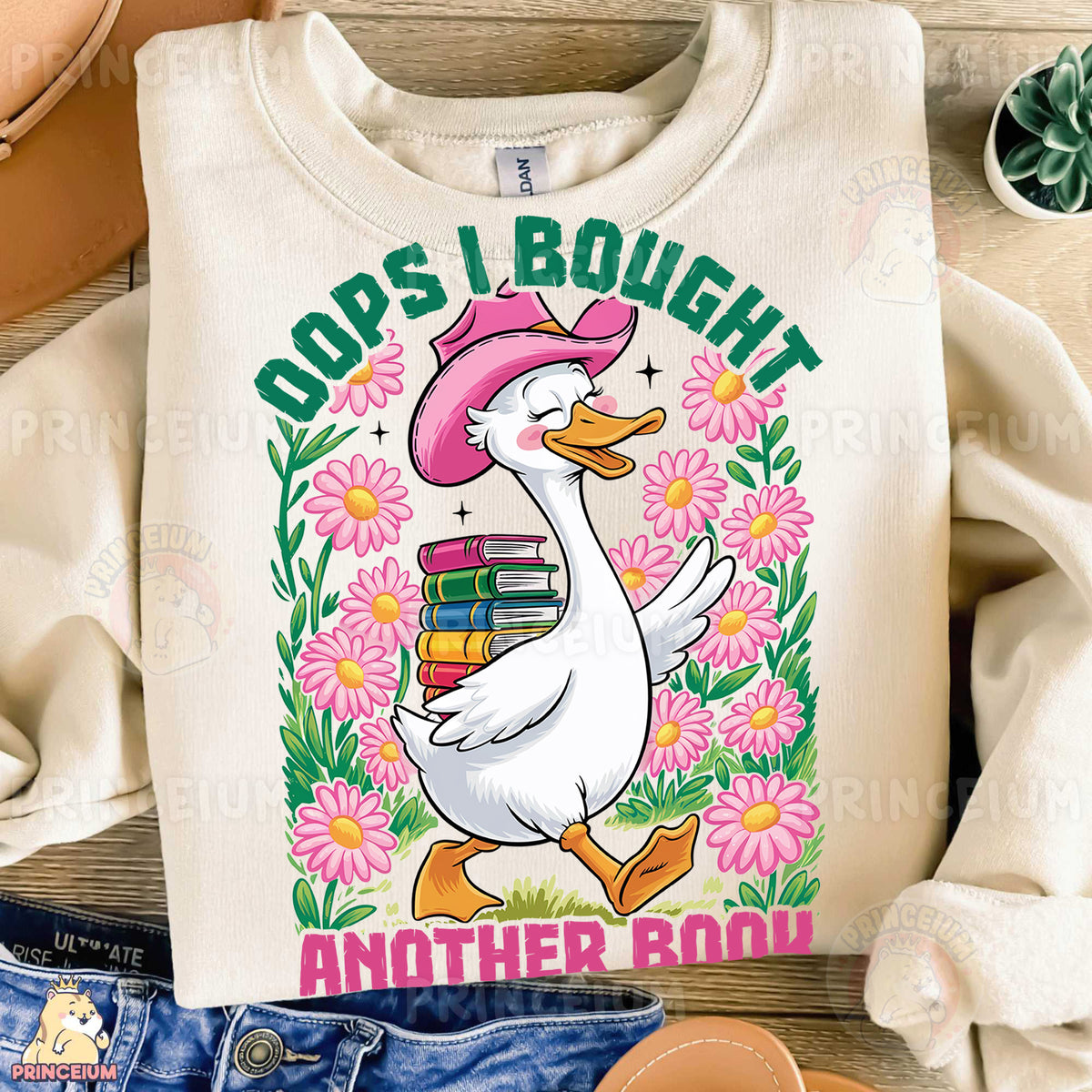 a white shirt with a duck wearing a pink hat and holding a stack of books
