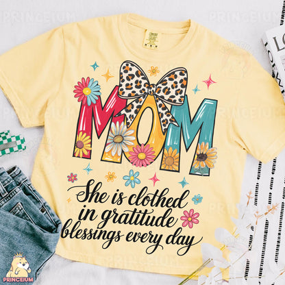 a shirt that says mom she is clothed in gratie and blessing every day