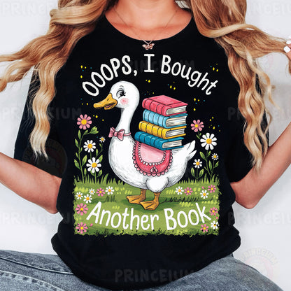 a woman wearing a black t - shirt with a goose holding a stack of books