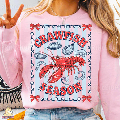 a woman wearing a pink shirt with a lobster on it