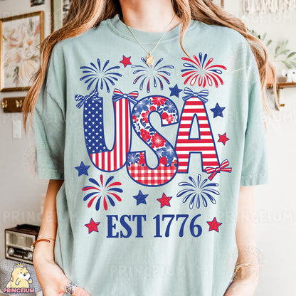 a woman wearing a usa t - shirt with fireworks in the background
