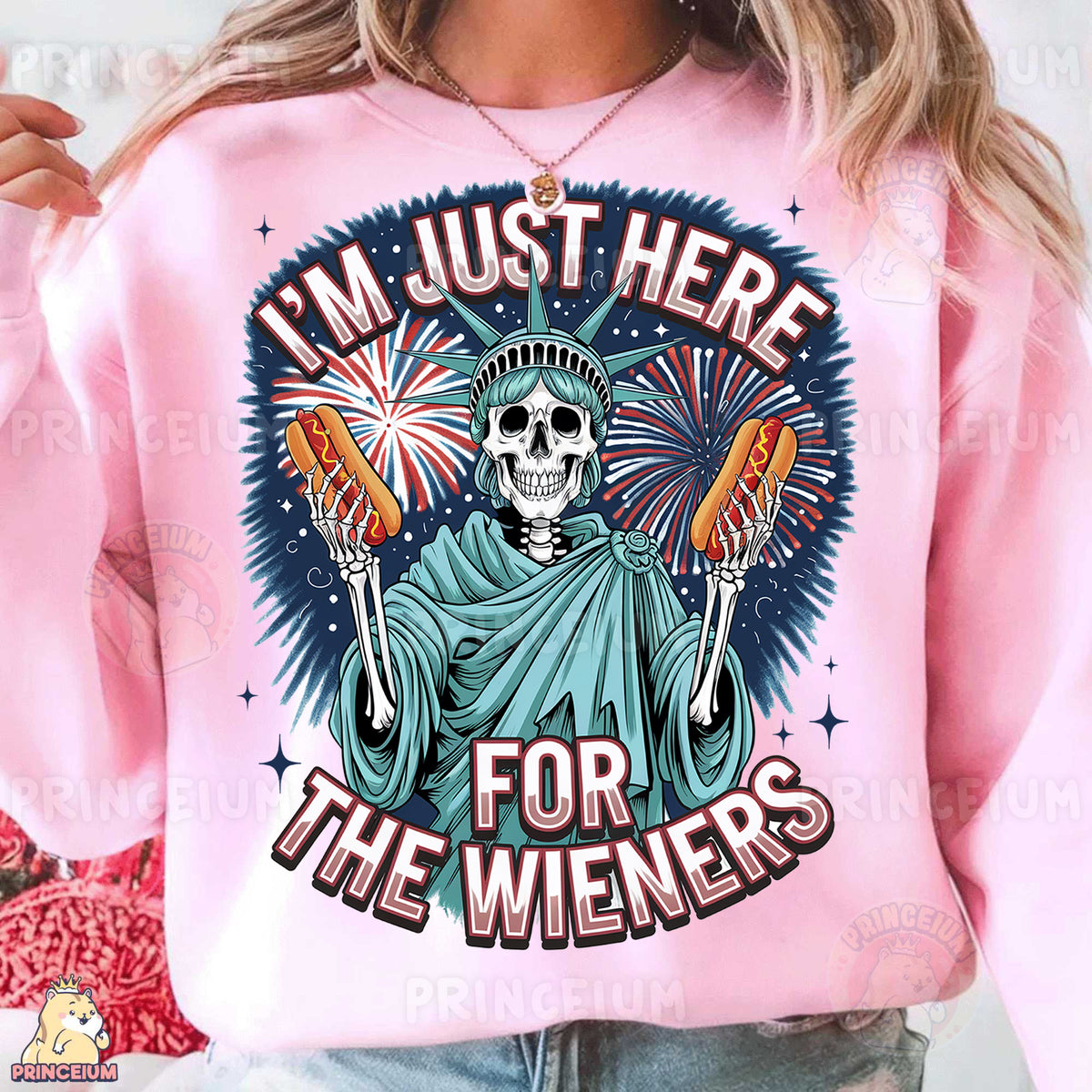 a woman wearing a pink sweatshirt that says i'm just here for the wiener