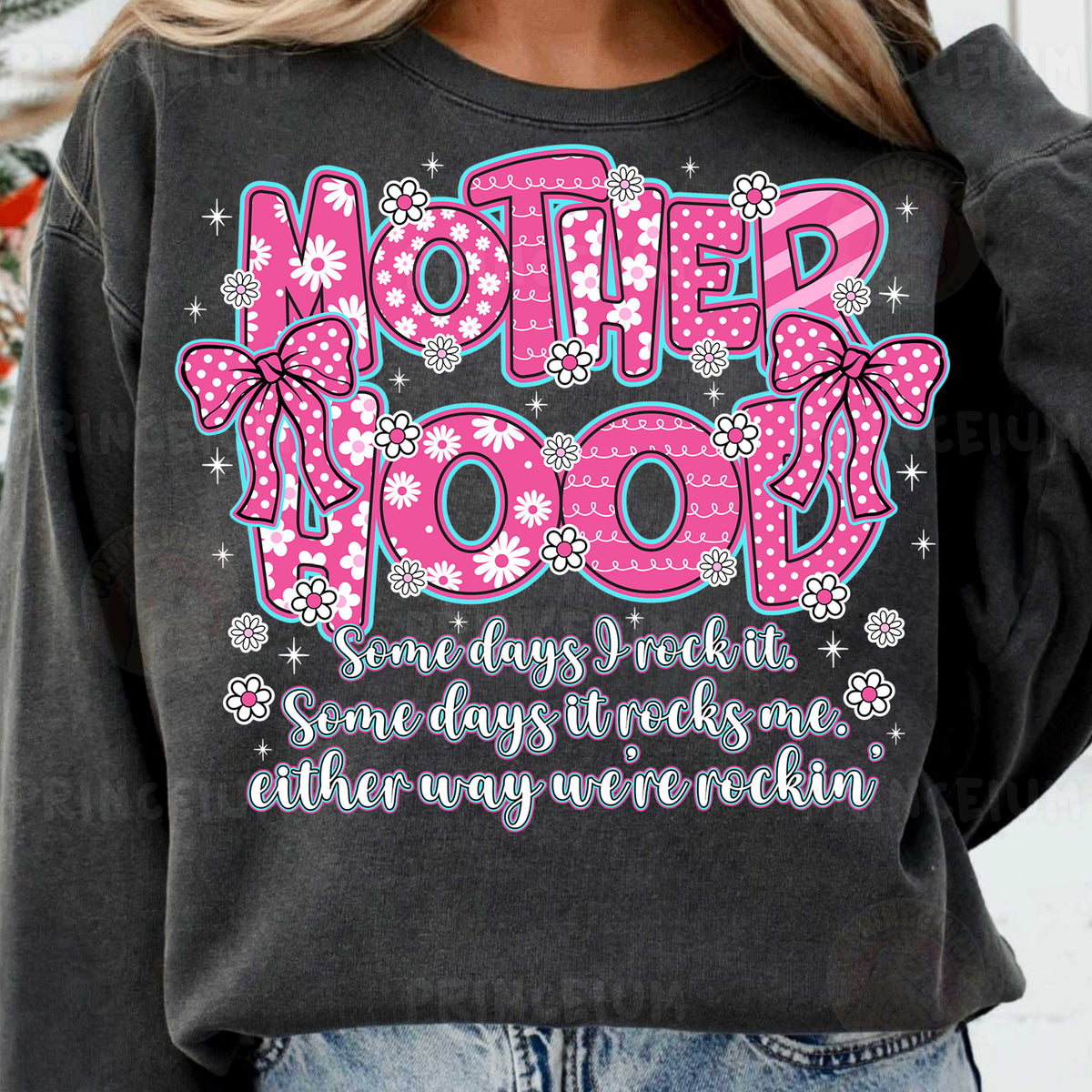a woman wearing a sweatshirt that says motherhood