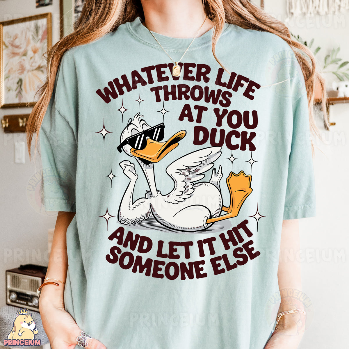 a woman wearing a t - shirt that says whatever life throws at you duck and