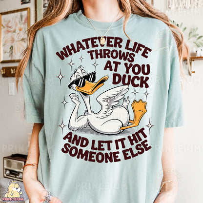 a woman wearing a t - shirt that says whatever life throws at you duck and