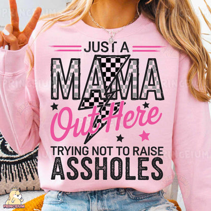 a woman wearing a pink shirt that says just a mama outside trying not to raise