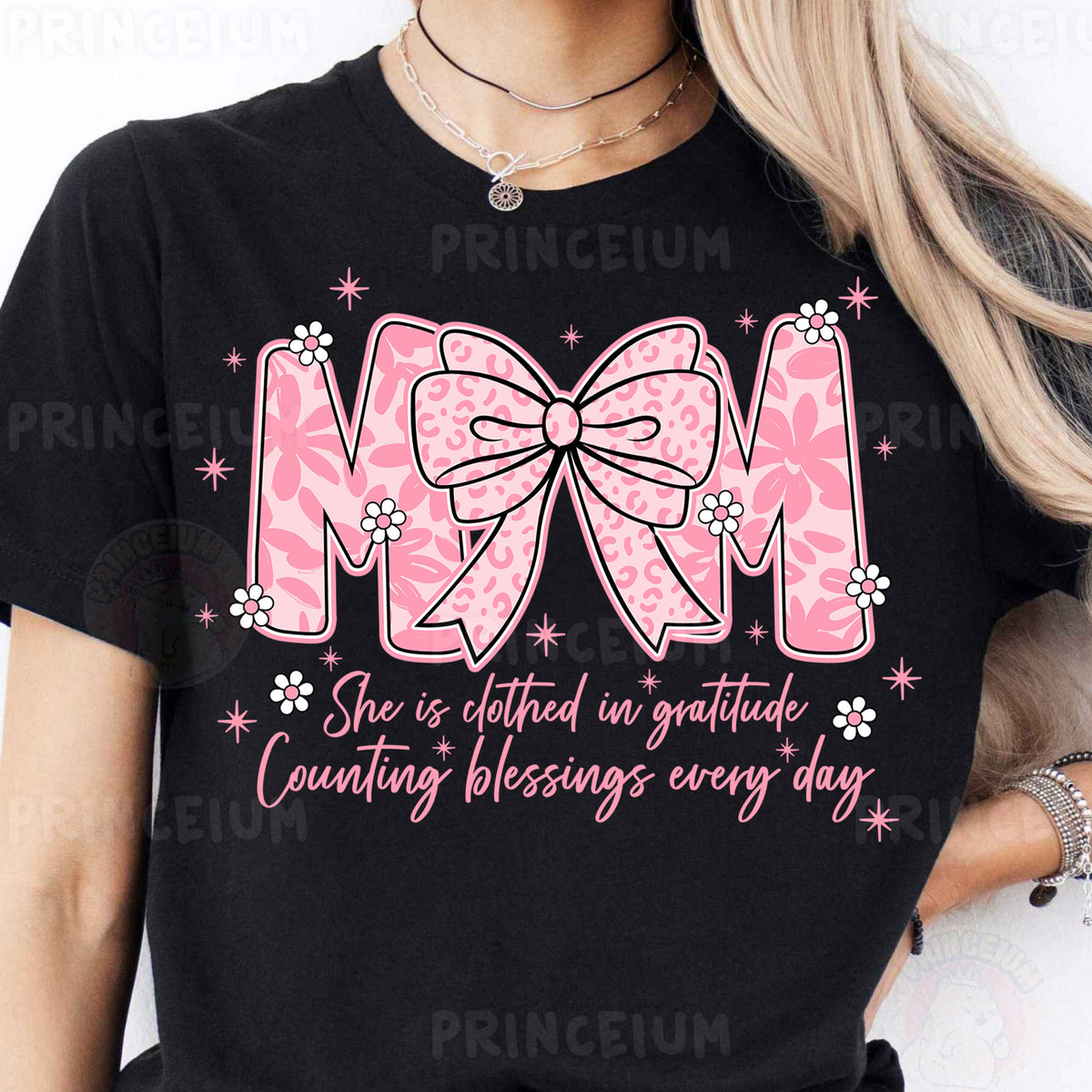 a woman wearing a black shirt with a pink bow