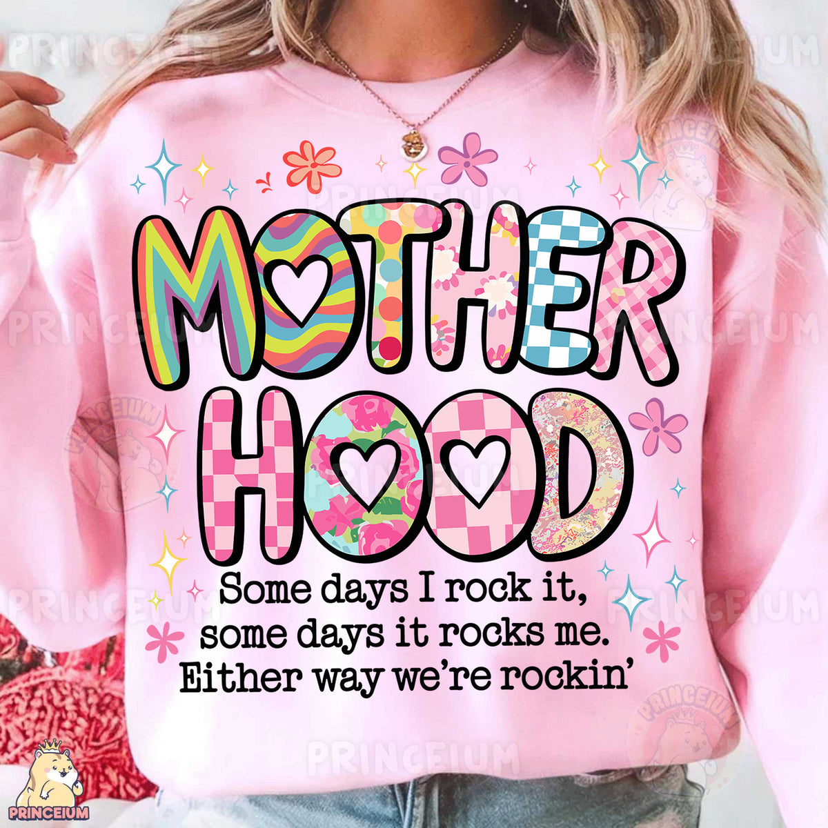 a woman wearing a pink sweatshirt that says motherhood