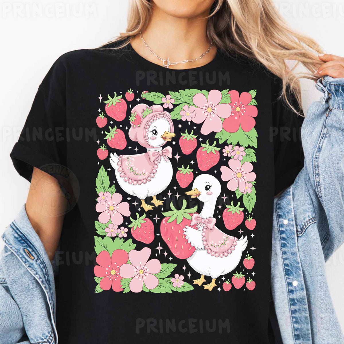 a woman wearing a black t - shirt with pink flowers and ducks on it