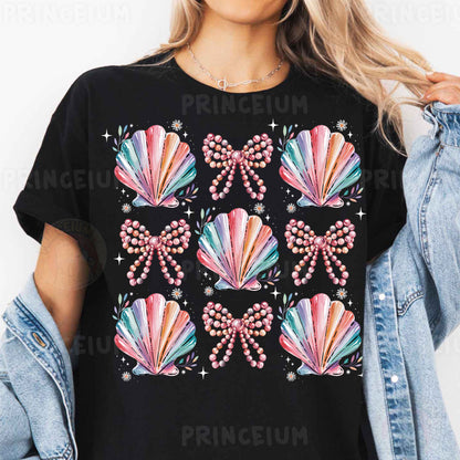 a woman wearing a black t - shirt with colorful seashells on it