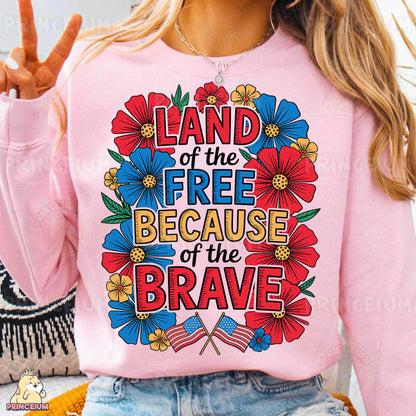 a woman wearing a pink shirt that says land of the free because of the brave