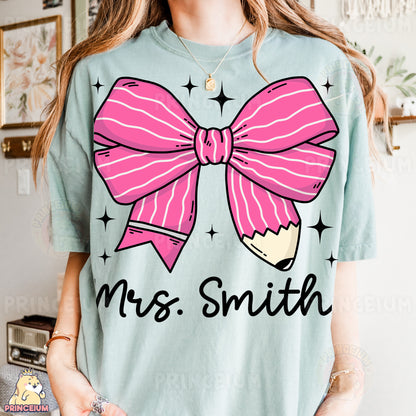 a woman wearing a t - shirt with a pink bow on it