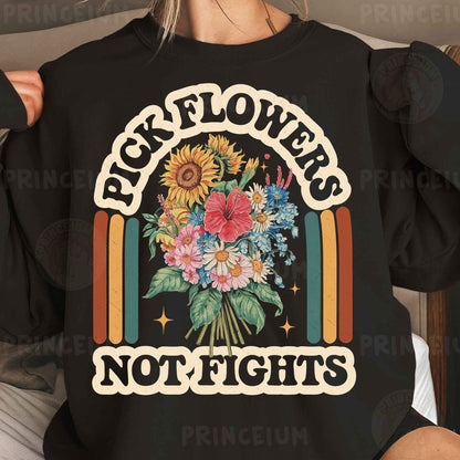 a woman wearing a black sweatshirt with flowers and rainbows on it