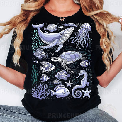 a woman wearing a black t - shirt with sea animals on it