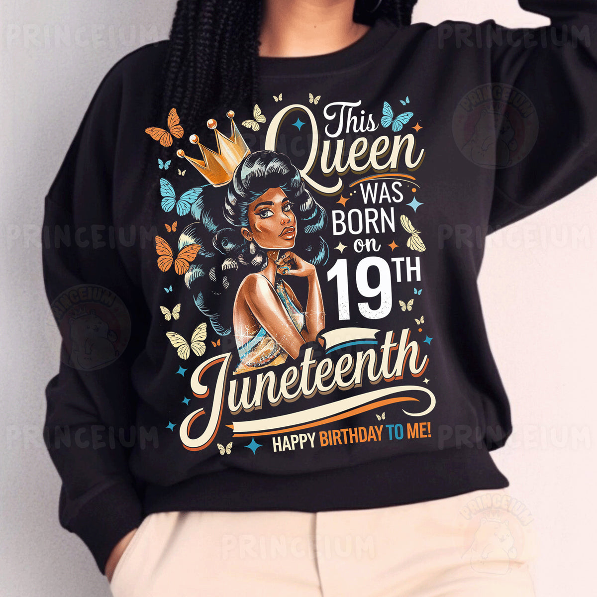a woman wearing a black sweatshirt with an image of a queen on it
