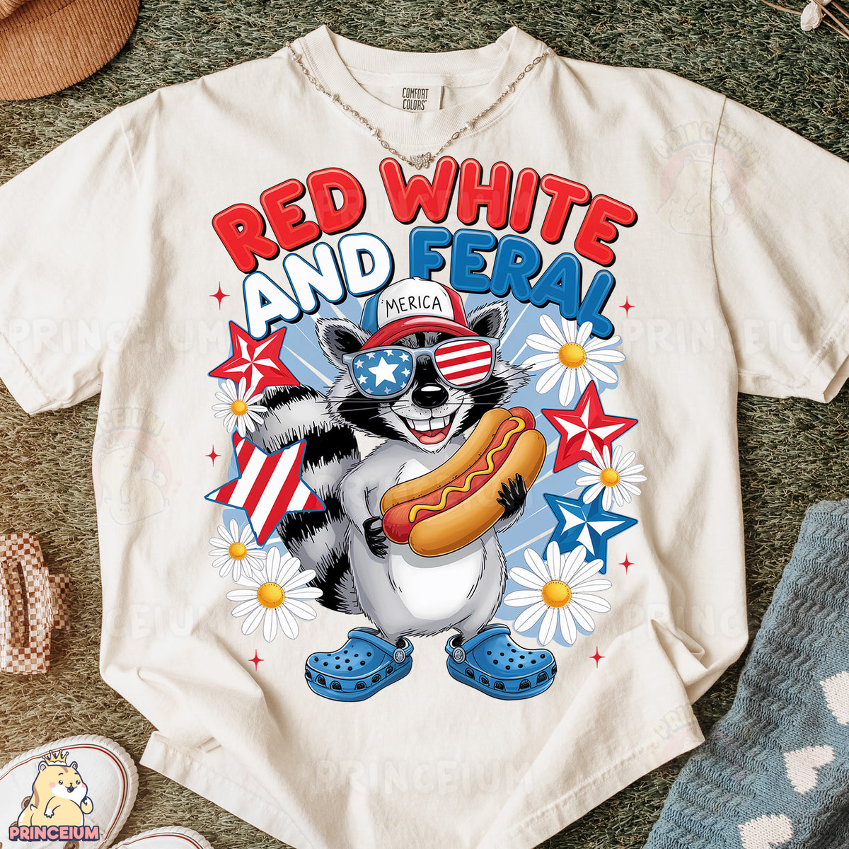 a white shirt with a raccoon holding a hot dog
