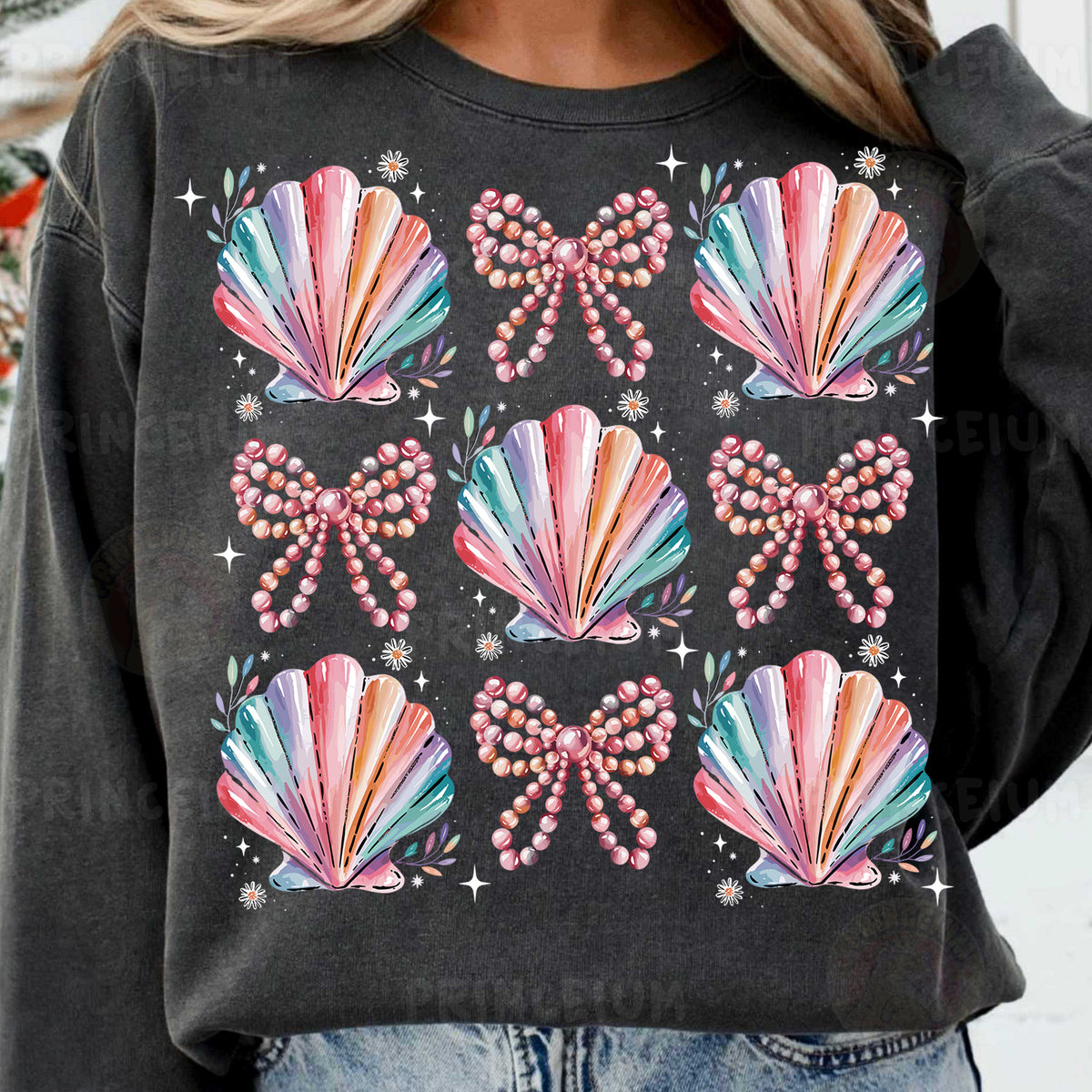 a woman wearing a black sweatshirt with colorful seashells on it