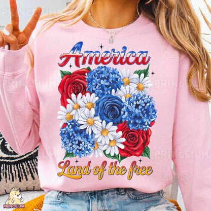 a woman wearing a pink american land of the free sweatshirt