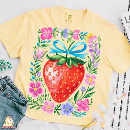 a yellow shirt with a picture of a strawberry on it