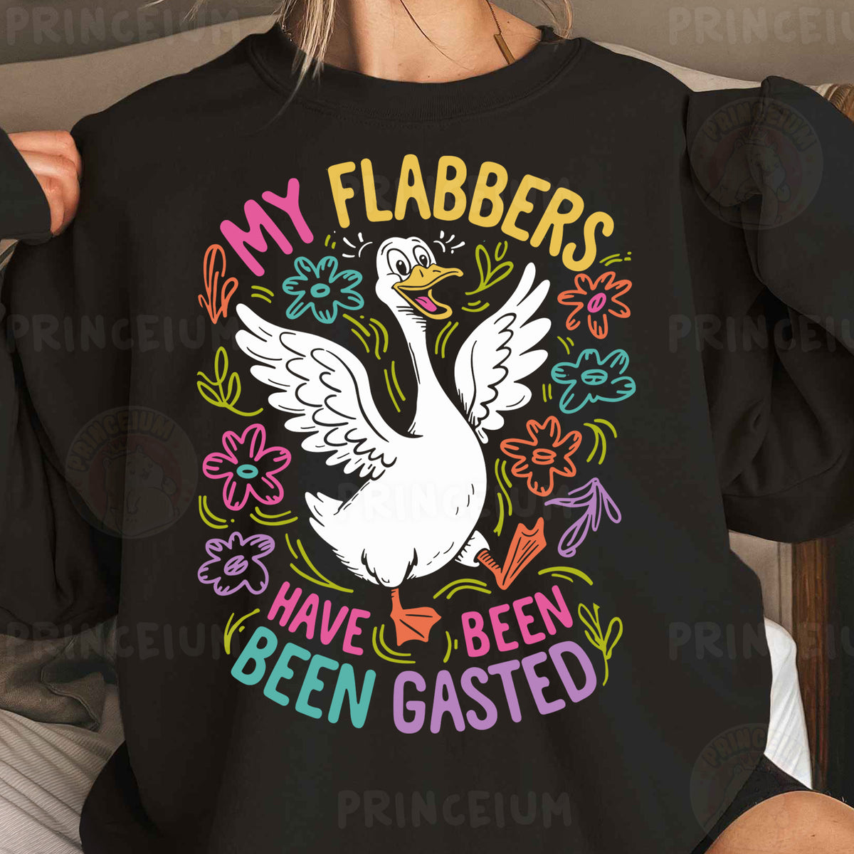 a woman wearing a black sweatshirt with a white goose on it
