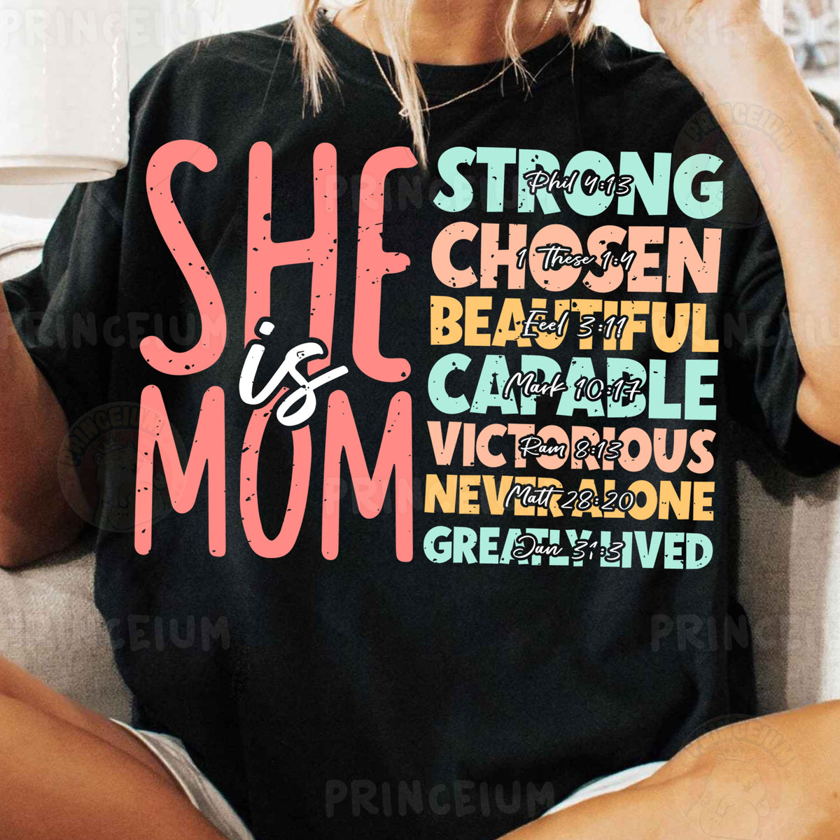 a woman sitting on a couch wearing a black shirt