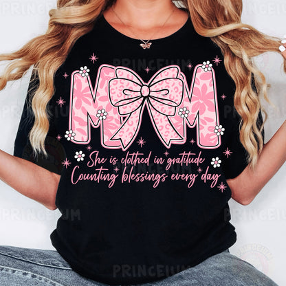 a woman wearing a black shirt with a pink bow