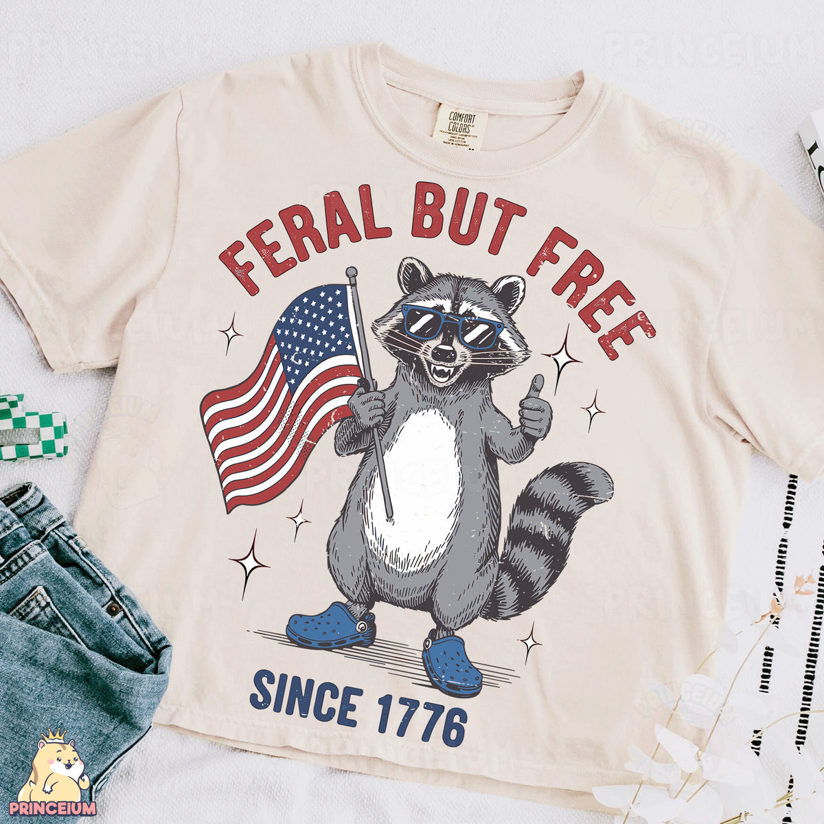 a t - shirt with a raccoon holding an american flag