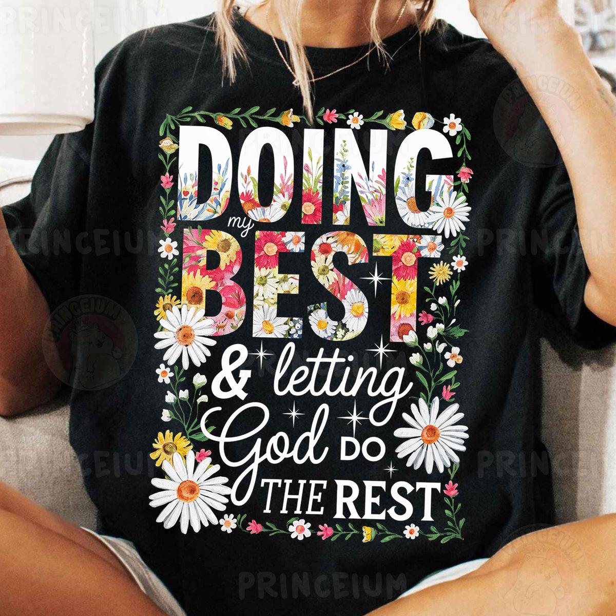 a woman sitting on a couch wearing a t - shirt that says doing best and