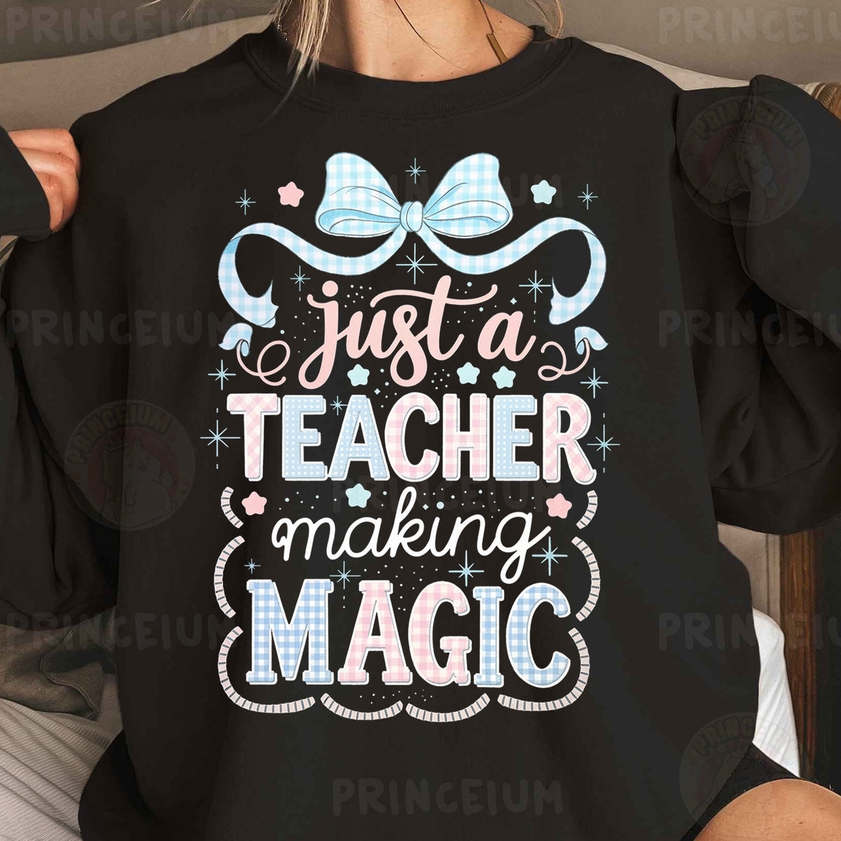 a woman wearing a black shirt that says just a teacher making magic