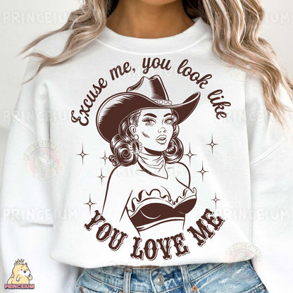 a woman wearing a white shirt with a cowboy hat on it