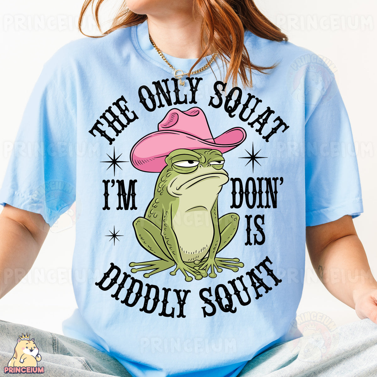 a woman wearing a blue shirt with a frog wearing a pink cowboy hat