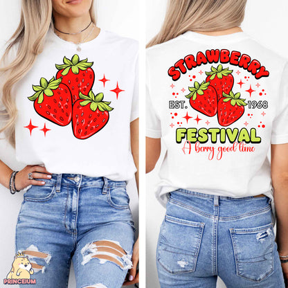 a woman wearing a white shirt with strawberries festival on it