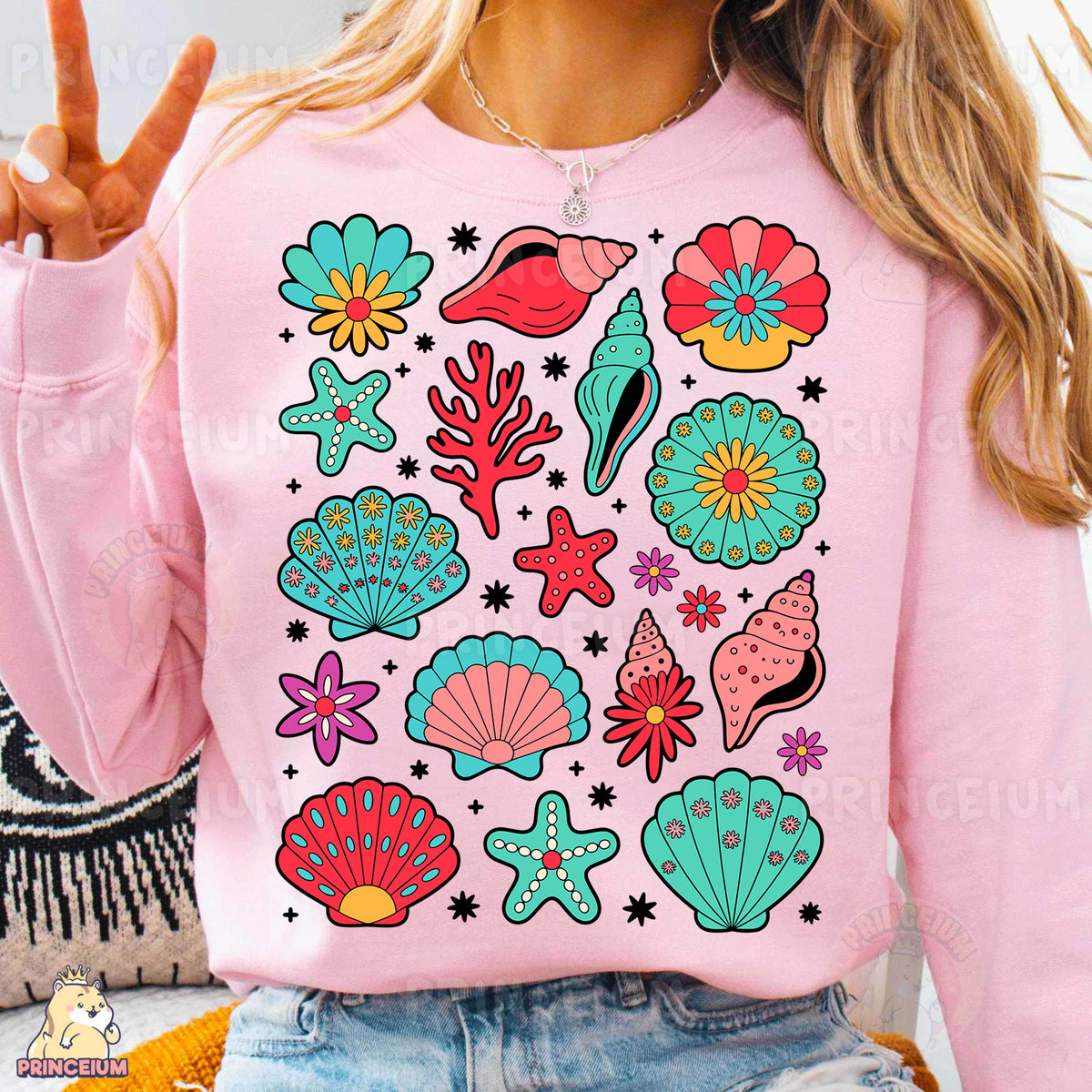 a woman wearing a pink sweater with colorful seashells on it
