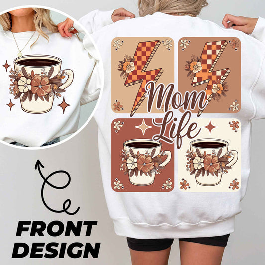 a woman wearing a sweatshirt with coffee mugs on it
