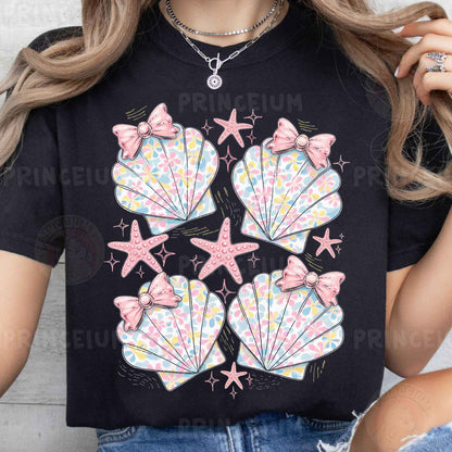 a woman wearing a t - shirt with seashells on it