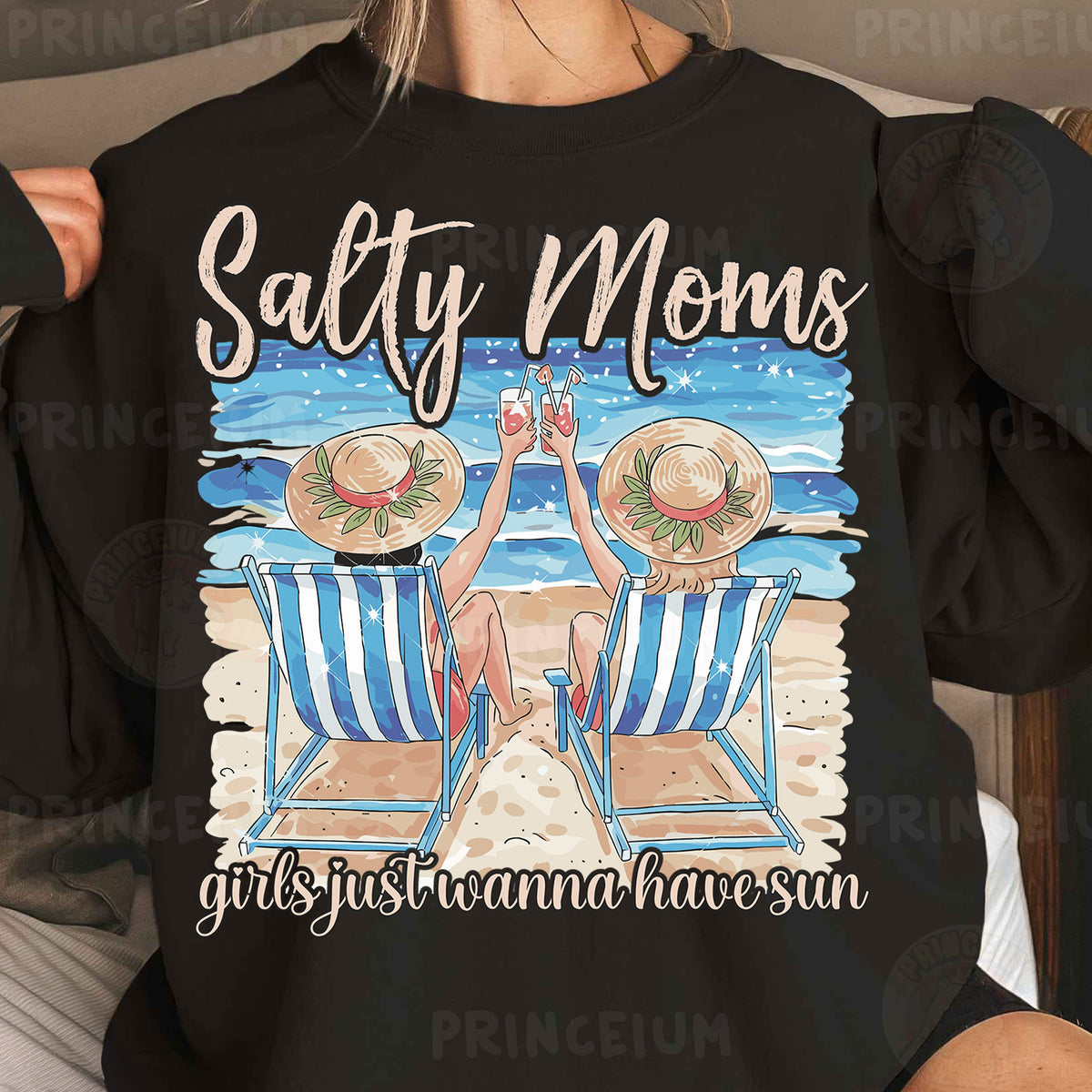 a woman wearing a black shirt with a picture of two chairs on the beach