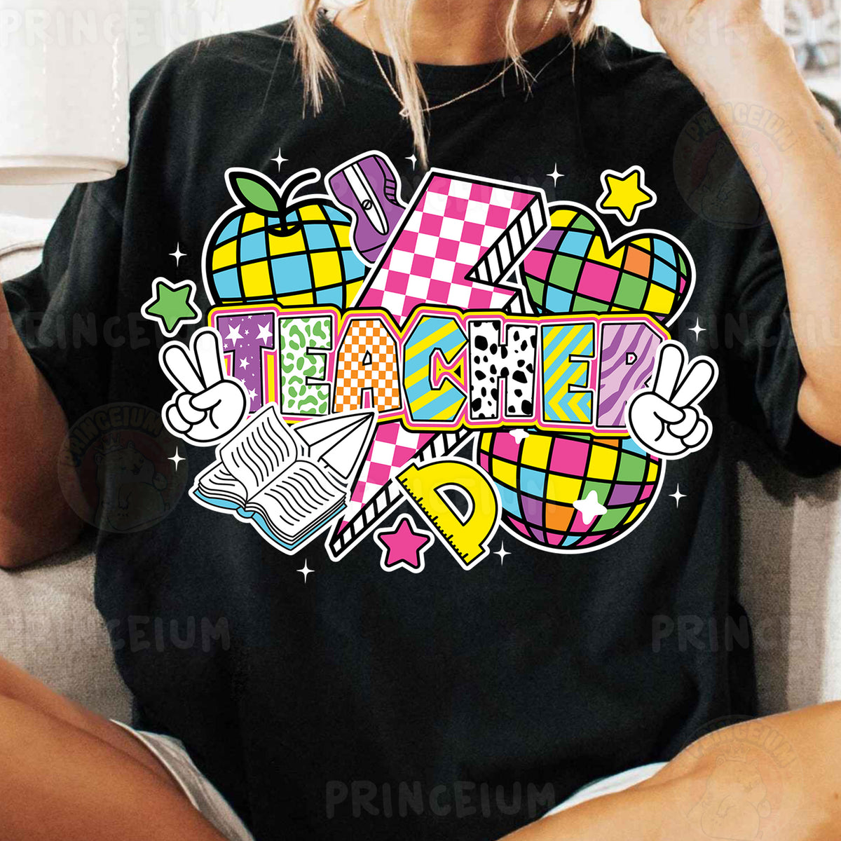 a woman sitting on a couch wearing a black shirt