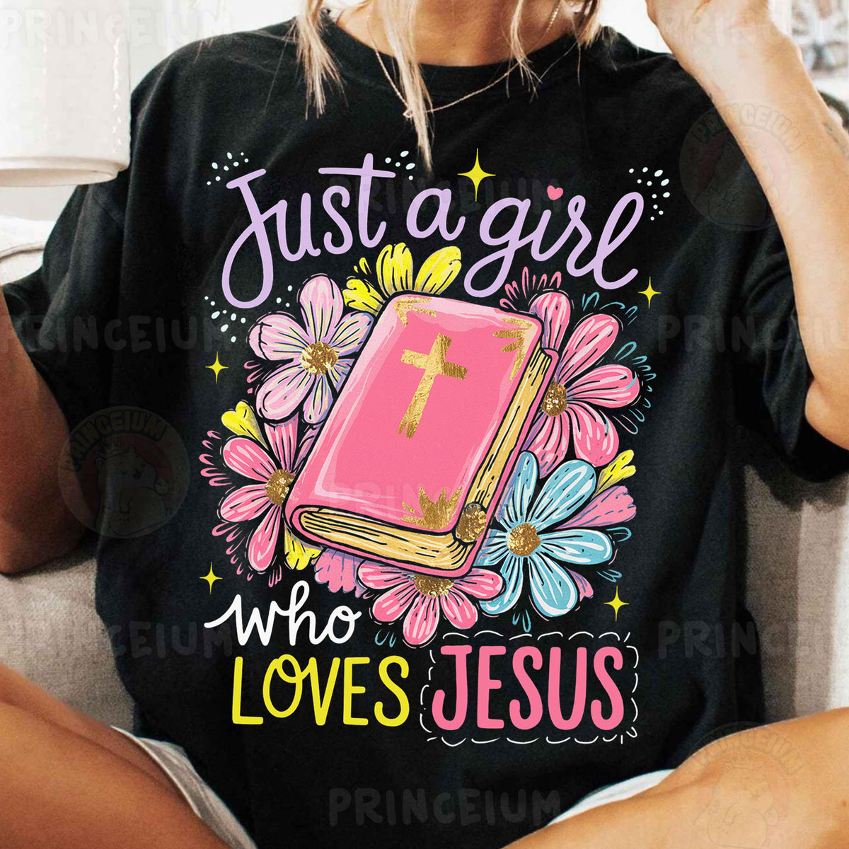 a woman sitting on a couch wearing a t - shirt that says just a girl